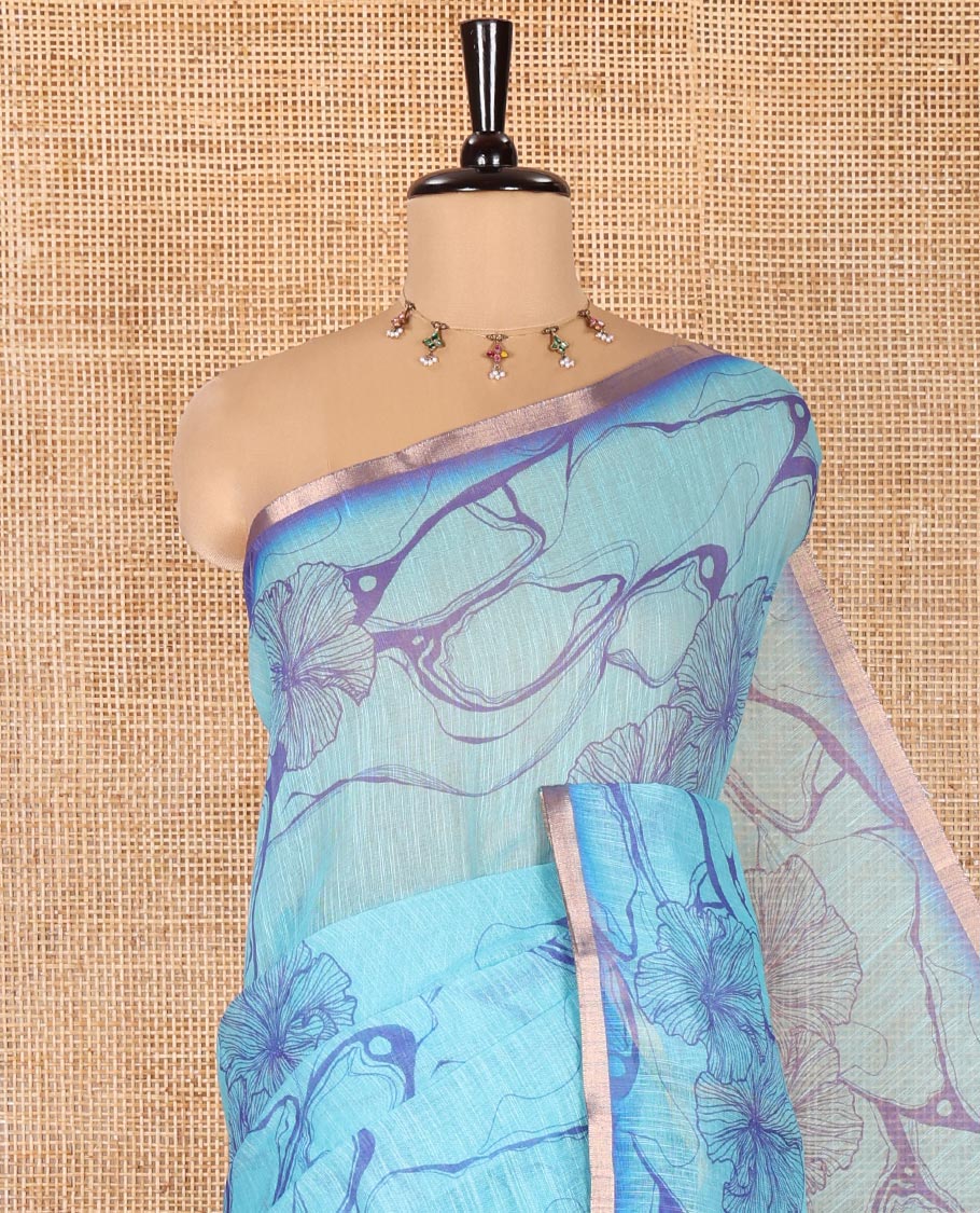 Blue Linen Cotton Saree, Adorned with Abstract Floral Print On Its Body, Subtle Piping Border, Pallu of Floral and Geometric Print, and Paired with a Contrast Blouse