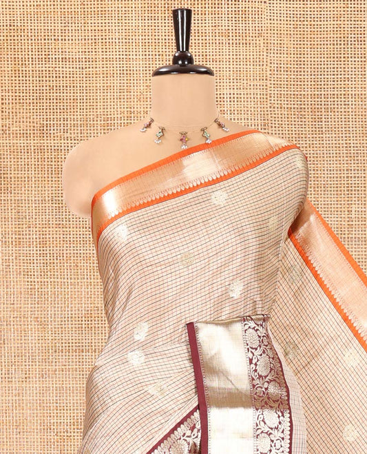 Chikku Soft Silk Saree, Subtly Woven with Vintage Checks On Its Body, Complemented by Contrast Traditional Zari Designs Woven Ganga Jamuna Border, Subtle Pallu and Paired with a Matching Blouse