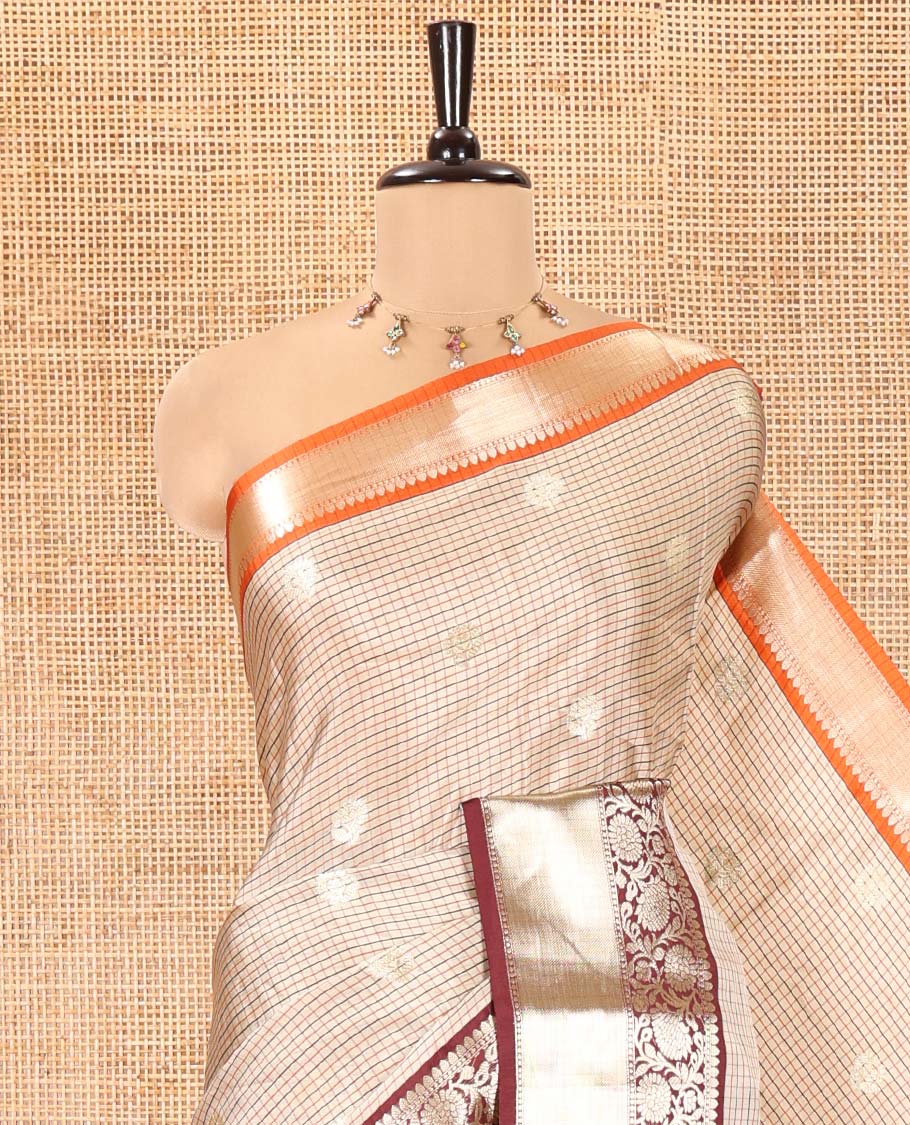 Chikku Soft Silk Saree, Subtly Woven with Vintage Checks On Its Body, Complemented by Contrast Traditional Zari Designs Woven Ganga Jamuna Border, Subtle Pallu and Paired with a Matching Blouse