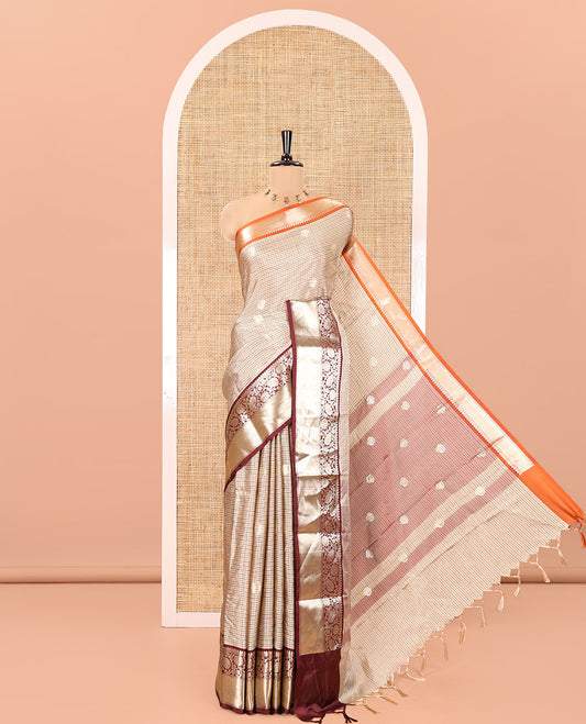 Chikku Soft Silk Saree, Subtly Woven with Vintage Checks On Its Body, Complemented by Contrast Traditional Zari Designs Woven Ganga Jamuna Border, Subtle Pallu and Paired with a Matching Blouse