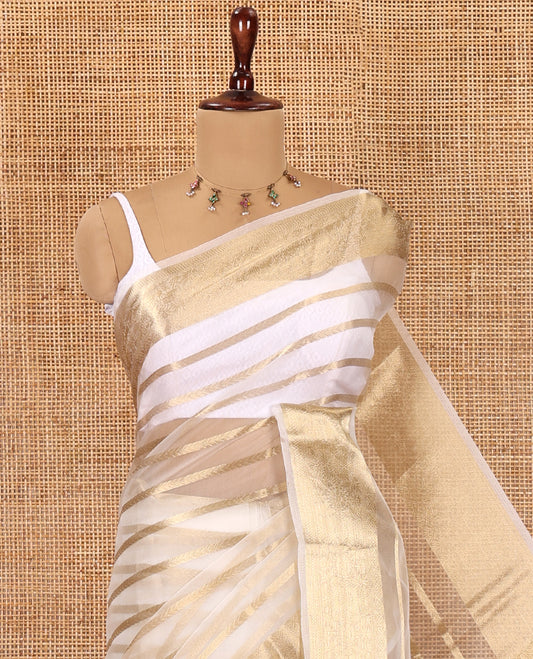 Cream Semi-Organza Saree, Boldly Accentuated with Zari Stripes, Highlighted by a Zari Traditional Border, and a Matching Blouse