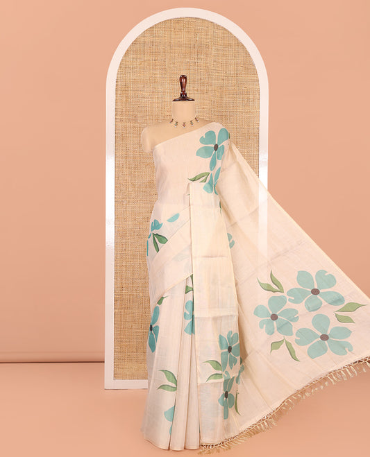 Borderless Cream-Sea Green Tissue Saree Features Floral Print, a Floral Printed Pallu, and a Contrast Blouse