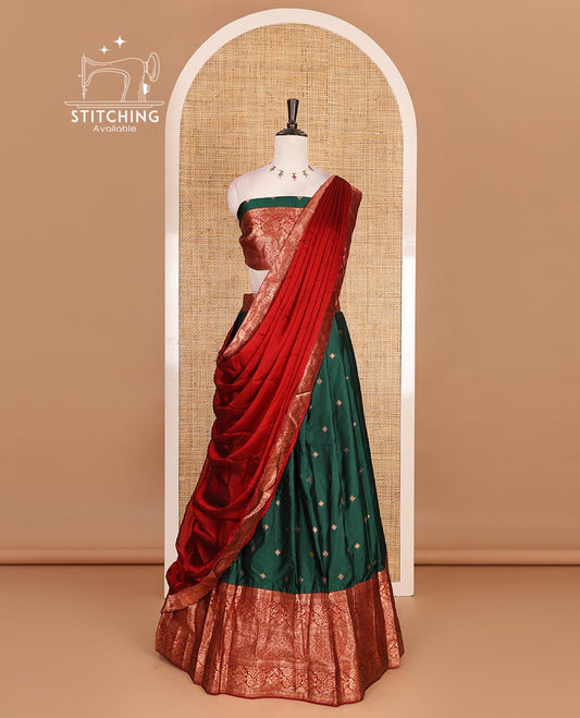 Dark green taffeta silk half saree, zari buttas with contrast red traditional zari border, matching zari blouse, and contrast plain zari border dhavani