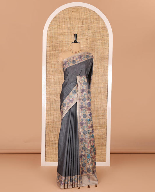 Grey plain fancy tussar saree, contrast floral creeper border, pallu of kalamkari floral vine print, and floral printed blouse