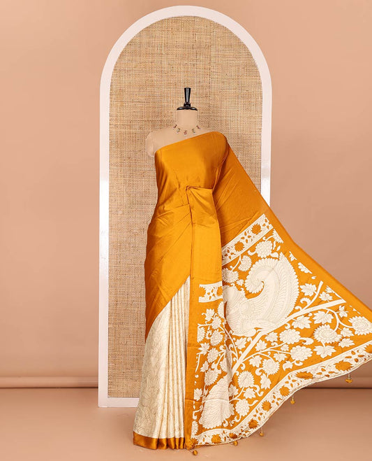 Chikku-mustard half-and-half plain and kalamkari floral printed satin crepe saree, plain border, pallu of floral vine and peacock printed, and kalamkari floral printed blouse