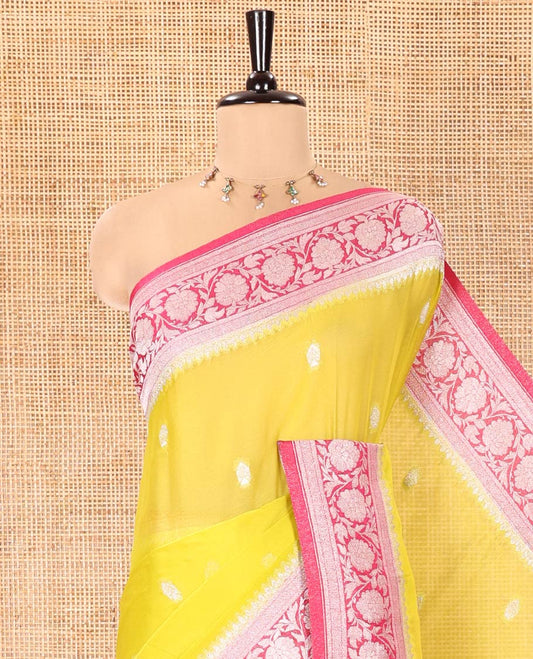 Green Banaras Fancy Georgette Saree, Decorated with Zari Buttas All Over Its Body, Complemented by a Contrast Floral Creeper Zari Border, Pallu Features Paisley Designs, and Paired with a Contrast Blouse