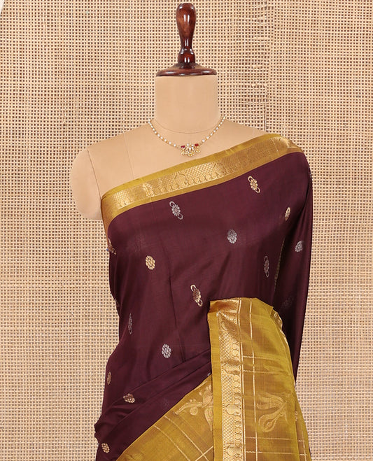 Maroon Uppada Silk Saree Elevated with Zari Buttas All Over Its Body, Complemented by Contrast Traditional Border of Peacock Veenai Designs, Sparsely Woven Pallu of Floral Designs, and Paired with a Contrast Blouse