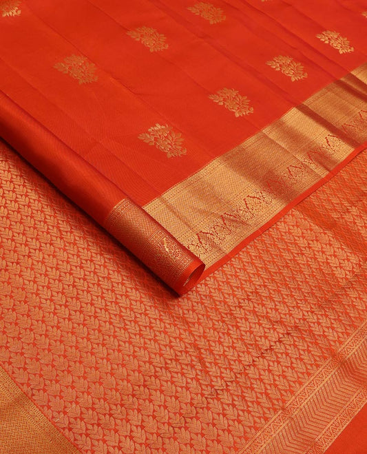 Orange zari buttas Vasundhara silk mix saree, contrast border of rekku, muthu, poun, vanki, and zari designs, and leaf vine design pallu