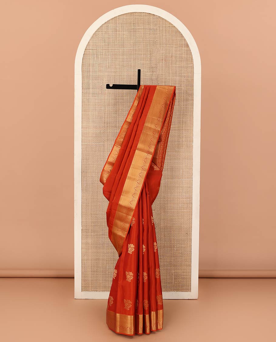 Orange zari buttas Vasundhara silk mix saree, contrast border of rekku, muthu, poun, vanki, and zari designs, and leaf vine design pallu