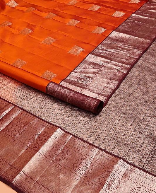 Orange Vasundhara Lite Silk Mix Saree Decorated with Zari Buttas, Complemented with a Contrast Border Featuring Chakram, Rudraksham, Vanki, Kathir, and Lavangam Designs, Zari Elevated Jaal Pallu, and Paired with a Contrast Blouse