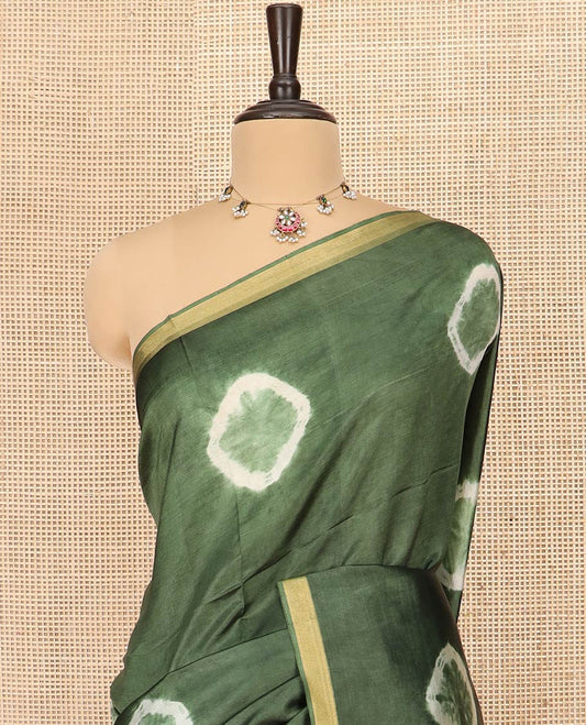 Green Banana Pith Saree Subtly Sparkled with Shibori Prints, Zari Bavanji Border, Complemented with a Contrast Printed Pallu of Shibori Motifs, and Paired with a Contrast Shibori Printed Blouse
