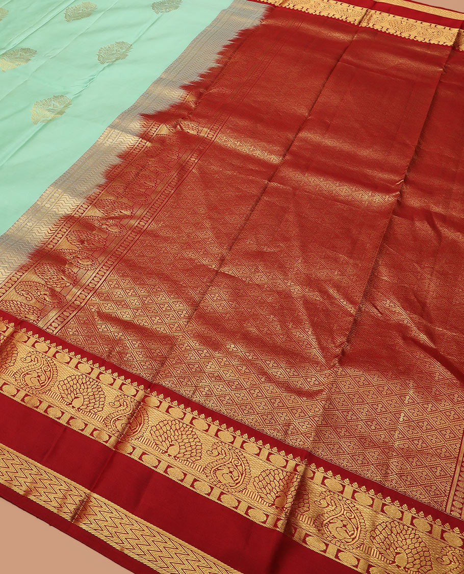 Sea green zari buttas silk saree, contrast korvai rettai pettu border of thilakam, mayil kann, rudraksham, and vanki designs, and jaal pallu