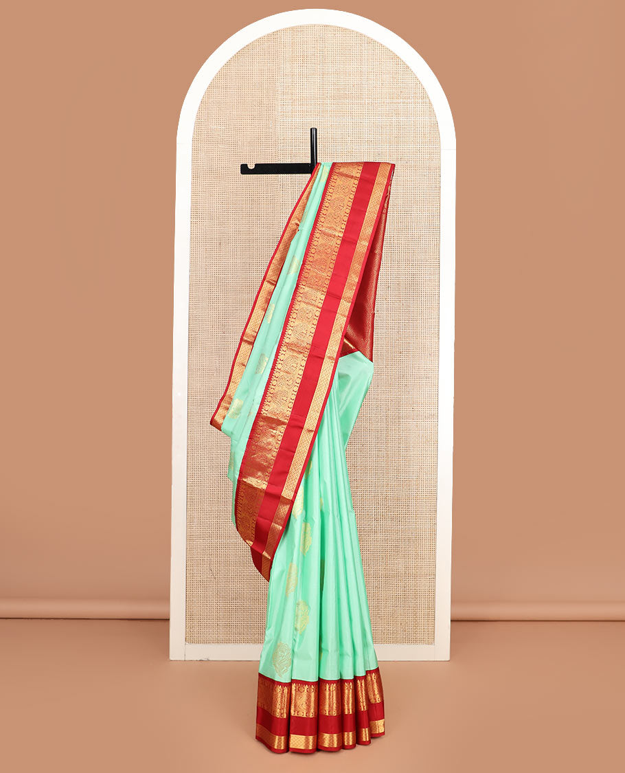 Sea green zari buttas silk saree, contrast korvai rettai pettu border of thilakam, mayil kann, rudraksham, and vanki designs, and jaal pallu