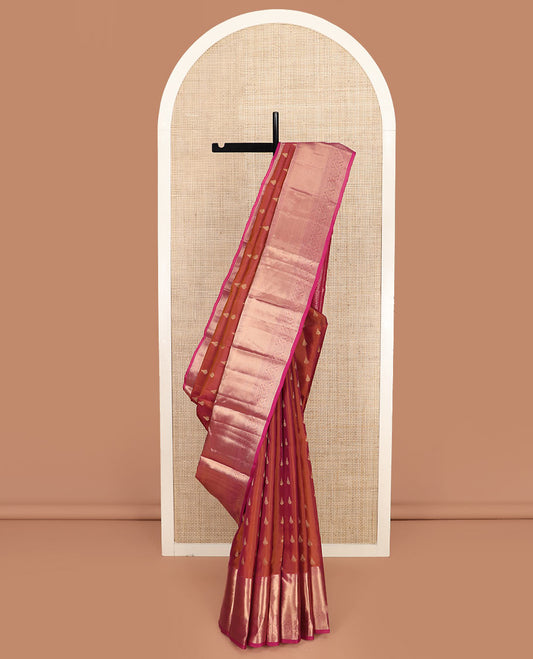 Orange Vasundhara Silk Saree Highlighted with Zari Buttas, Complemented by a Contrast Border of Rekku, Kathir, Mayil Kann, and Dhavana Kodi Designs, Grandly Woven Pallu of Jaal Designs, and a Contrast Blouse