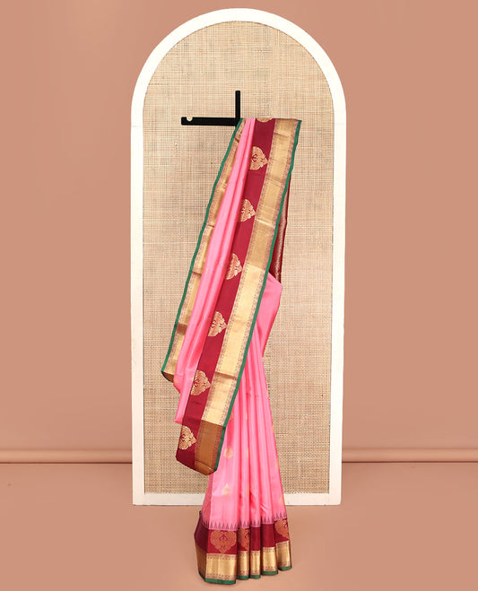 Pink Vasundhara Silk Saree, Finely Designed with Zari Buttas All Over Its Body, Complemented by Contrast Temple Border of Mayil, Rudraksham, and Mayil Kann Designs, Grand Jaal Pallu, and Paired with a Contrast Blouse