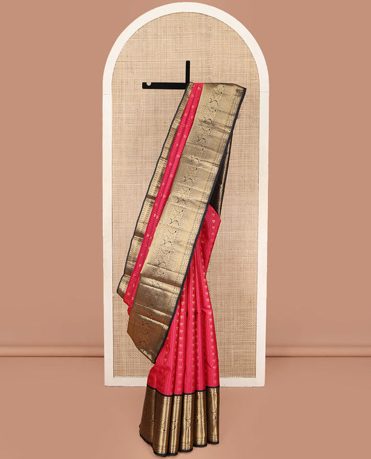 Red Vasundhara Silk Saree, Subtly Sparkled with Buttas and Stripes All Over Its Body, Complemented by Contrast Zari Border of Diamond, Mayil Kann, Manga, and Kodi Visiry Designs, Opulently Embellished Pallu, and Paired with a Contrast Blouse