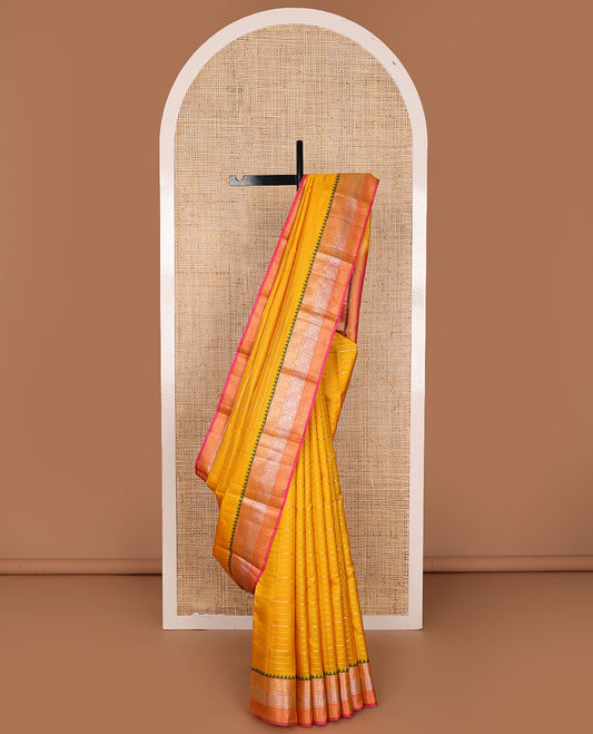 Yellow zari buttas silk saree, contrast ogee patterned pallu &  floral jaal enclosed checked thazampoo rekku border