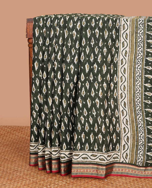 Green pine tree style motifs printed mul mul cotton saree, contrast traditional motifs border, and pallu of floral and pine tree motifs print
