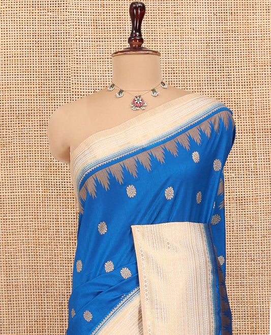 Peacock Blue Dupion Silk Saree, Ornamented with Zari Buttas All Over Its Body, Complemented by a Contrast Temple Traditional Zari Design Woven Border, Traditional Pallu of Temple Designs, and Paired with a Contrast Blouse