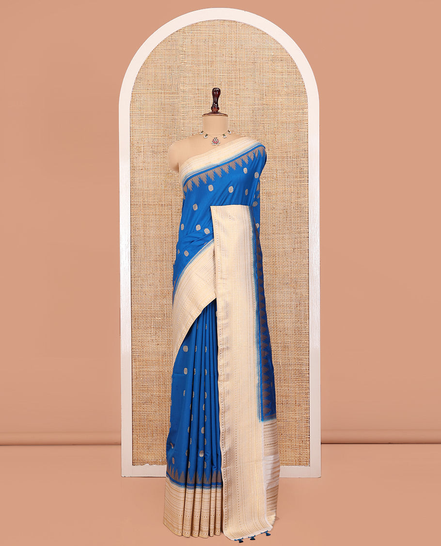 Peacock Blue Dupion Silk Saree, Ornamented with Zari Buttas All Over Its Body, Complemented by a Contrast Temple Traditional Zari Design Woven Border, Traditional Pallu of Temple Designs, and Paired with a Contrast Blouse
