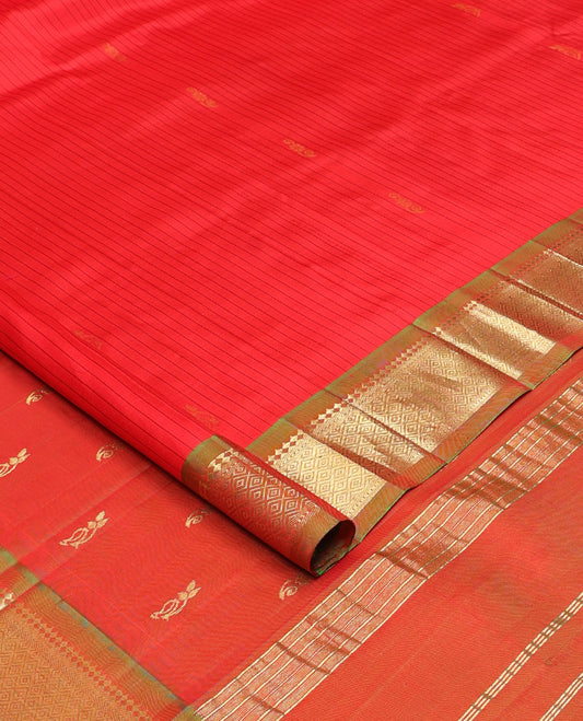 Red striped and zari buttas Kanchipuram silk saree, contrast one-sided border of paneer sombu, banars, and mayil kann designs, and zari design pallu