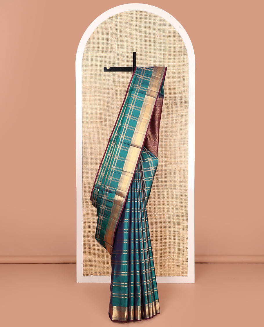 Green butta enclosed checked soft silk saree, zari border of thilakam mokku, banaras, muthu, puli nagam, and vanki designs, and contrast pallu of mayil and yaanai designs