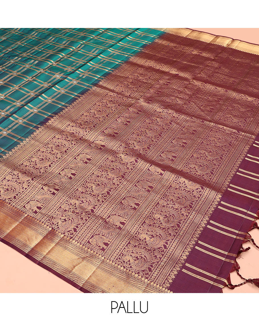 Green butta enclosed checked soft silk saree, zari border of thilakam mokku, banaras, muthu, puli nagam, and vanki designs, and contrast pallu of mayil and yaanai designs