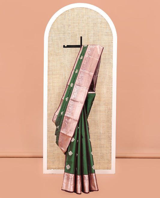 Green Vasundhara Lite Silk Mix Saree, Masterfully Woven with Zari Buttas All Over Its Body, Complemented by a Contrast Border of Thilakam, Diamond, Kodi Visiry, and Mayil Kann Designs, Grand Jaal Pallu, and Paired with a Contrast Blouse