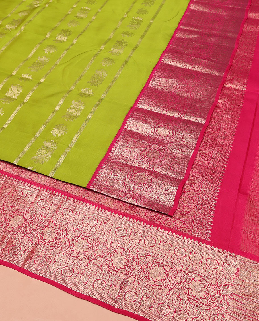Parrot Green Vasundhara Silk Saree, Artfully Detailed with Zari Designs, Complemented by a Contrast Border of Thilakam Mokku, Muthu, Mayil, Chakra, Kuyil Kann, and Kodi Visiry Designs, Pallu of Floral Jaal Designs, and Paired with a Contrast Blouse
