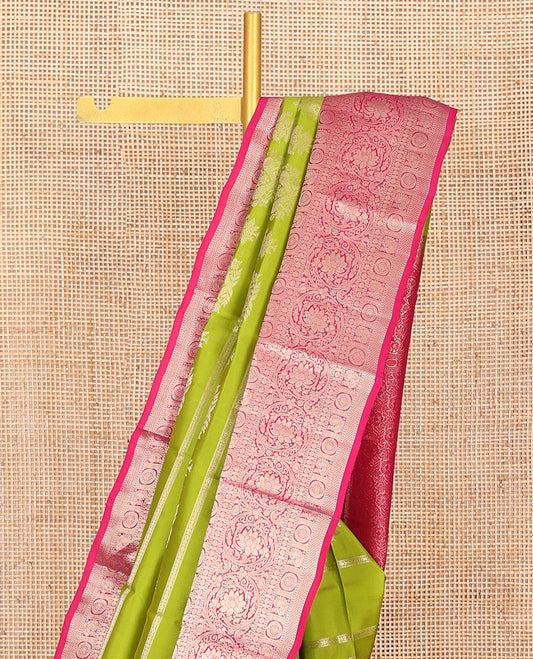 Parrot Green Vasundhara Silk Saree, Artfully Detailed with Zari Designs, Complemented by a Contrast Border of Thilakam Mokku, Muthu, Mayil, Chakra, Kuyil Kann, and Kodi Visiry Designs, Pallu of Floral Jaal Designs, and Paired with a Contrast Blouse