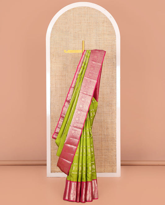 Parrot Green Vasundhara Silk Saree, Artfully Detailed with Zari Designs, Complemented by a Contrast Border of Thilakam Mokku, Muthu, Mayil, Chakra, Kuyil Kann, and Kodi Visiry Designs, Pallu of Floral Jaal Designs, and Paired with a Contrast Blouse