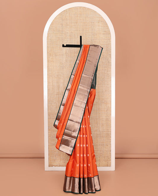 Orange Vasundhara Silk Saree, Embellished with Mayil and Yaali Butta Enclosed Checks on Its Body, Complemented by Contrast Border of Muthu, Rekku, Mayil, and Mayil Kann Designs, Grandly Decked Up Pallu, and Paired with a Contrast Blouse