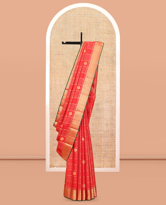 Red Vasundhara Silk Saree, Spotlighted with Chakram Buttas and Checks, a Zari Border of Rekku, and Chakram Designs, a Gleamed Up Pallu, and a Contrast Blouse