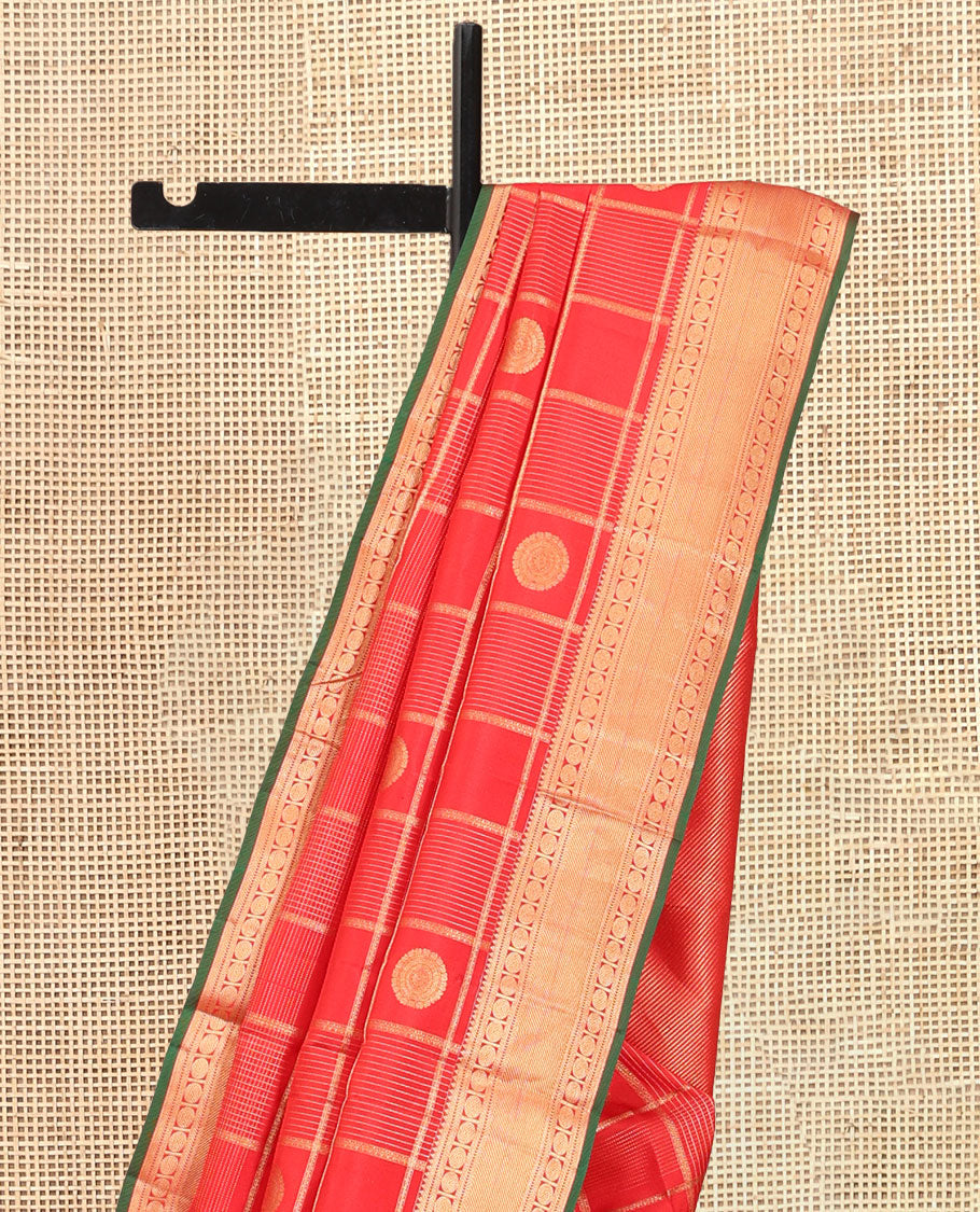 Red Vasundhara Silk Saree, Spotlighted with Chakram Buttas and Checks, a Zari Border of Rekku, and Chakram Designs, a Gleamed Up Pallu, and a Contrast Blouse