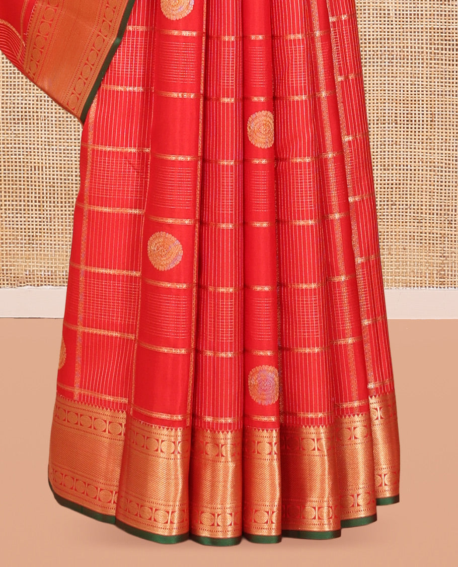 Red Vasundhara Silk Saree, Spotlighted with Chakram Buttas and Checks, a Zari Border of Rekku, and Chakram Designs, a Gleamed Up Pallu, and a Contrast Blouse