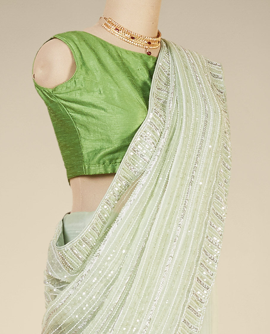 Stunning pastel green organza saree with gleaming sequin embroidery all over the saree