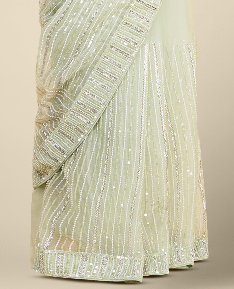 Stunning pastel green organza saree with gleaming sequin embroidery all over the saree
