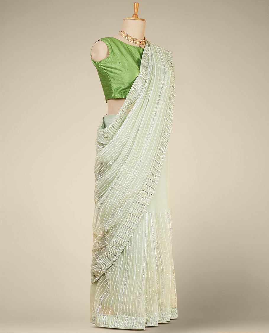 Stunning pastel green organza saree with gleaming sequin embroidery all over the saree