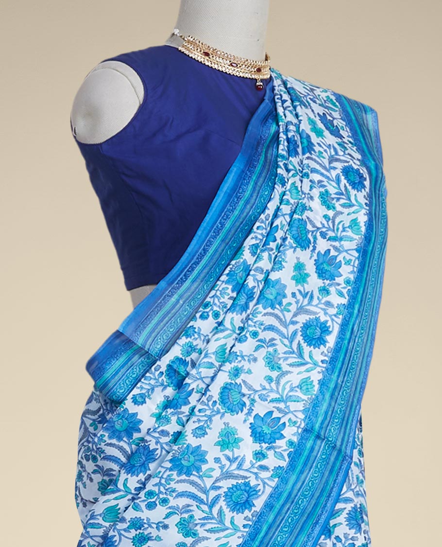 Blue floral vine design printed silk saree with contrast striped zari border