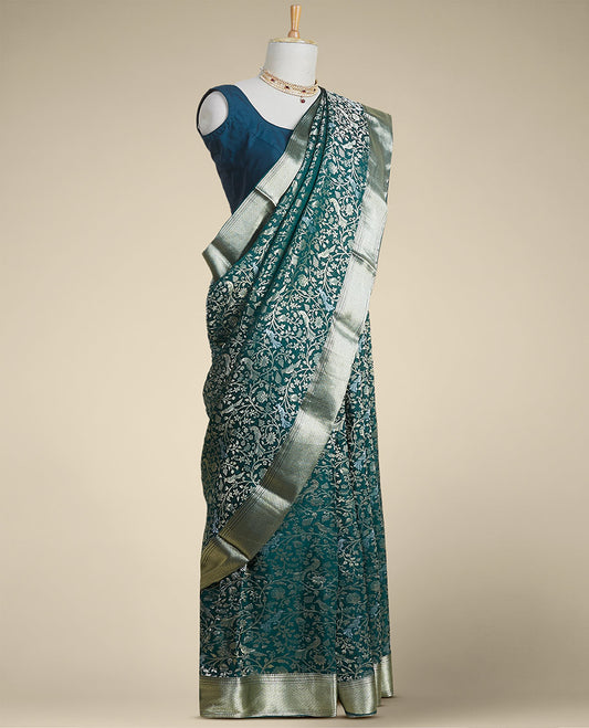 Green floral embroidery pure crepe saree with self intricate zari design border