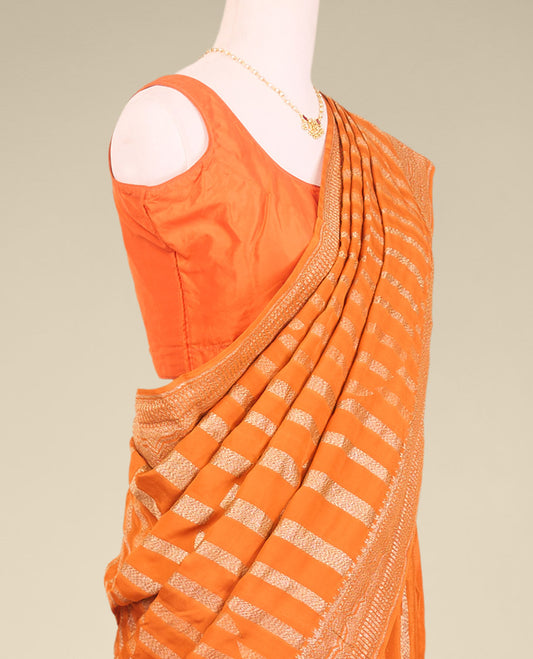 Orange striped crepe saree with self intricate zari design border