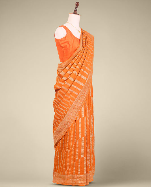 Orange striped crepe saree with self intricate zari design border