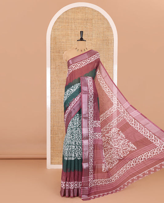 Green batik printed linen cotton saree, contrast printed and zari work border, batik printed pallu, and a contrast printed blouse