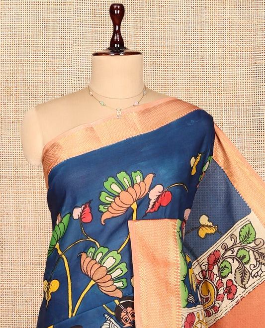 Blue Kalamkari Silk Saree, Opulently Embellished with Floral Vine and Ancient Human Motifs Print, a Contrast Traditional Zari Border, Pallu Features Peacock, and a Contrast Blouse