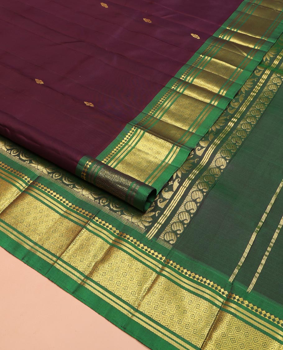 Maroon Kanchipuram Silk Saree, Spotlighted with Zari Buttas on Its Body, Complemented by a Contrast One-Sided Border of Panner Sombu, Banaras, and Jaal Designs, Pallu Features Floral Zari Designs, and Comes Without a Blouse