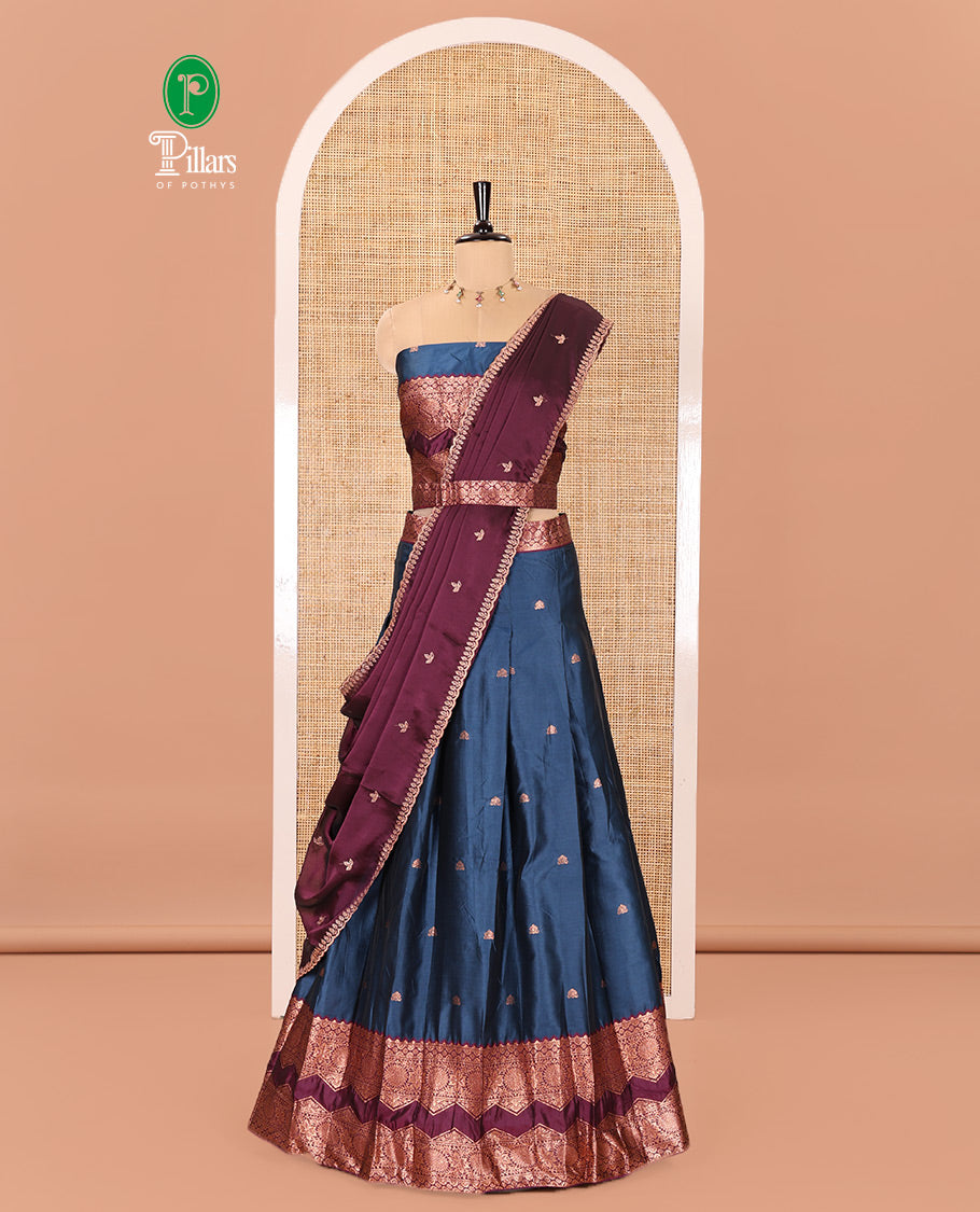 Peacock Blue and Purple Semi-Banarasi Half-Saree Elevated with Zari Buttas on Its Skirt, Complemented by Contrast Traditional Zari Border of Chakram Designs, Paired with a Matching Blouse, and a Satin Georgette Embroidered Scallop Dhavani