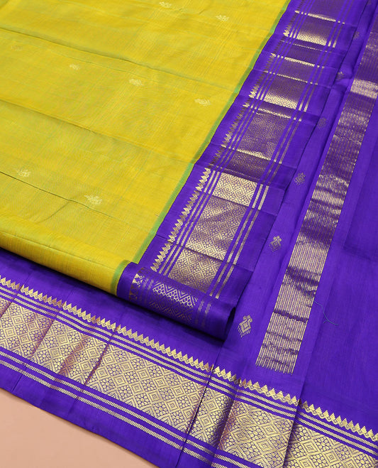 Green Kanchipuram Silk Saree, Woven with Zari Buttas on Its Body, Complemented by a Contrast One-Sided Korvai Border of Thilakam Mokku, Banaras, and Jaal Designs, Pallu of Zari Designs, and Comes Without a Blouse
