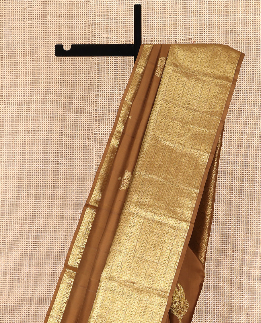 Brown Kanchipuram Silk Saree, Elevated with Zari Buttas All Over Its Body, Highlighted by Zari Wedding-themed Border of Manga, and Kamalam Designs, Grand Jaal Pallu, and Paired with a Matching Blouse