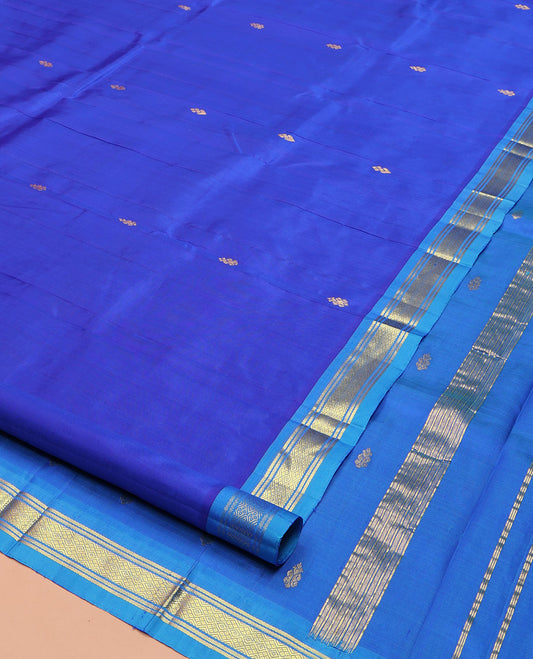 Blue Kanchipuram Silk Saree, Subtly Enriched with Zari Buttas on Its Body, Complemented by a Contrast One-Sided Border of Banaras, and Jaal Designs, Pallu of Zari Designs, and Comes Without a Blouse