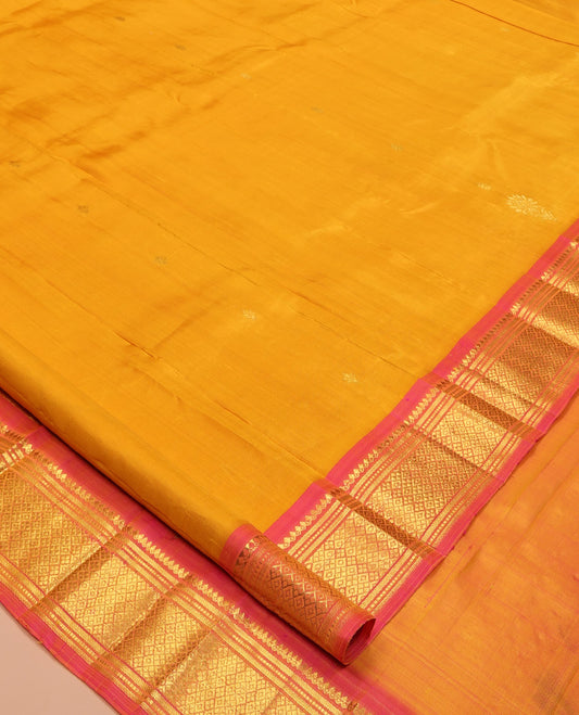 Orange Kanchipuram Silk Saree, Subtly Woven with Zari Buttas, Complemented by Contrast One-Sided Border of Thilakam Mokku, Banaras, Muthu, and Jaal Designs, Zari Design Pallu, and No Blouse
